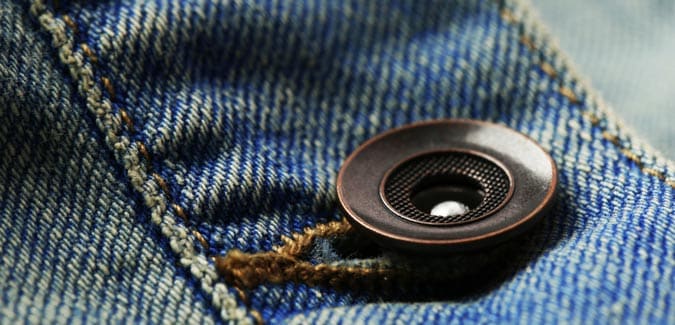 brass jeans button attached on denim